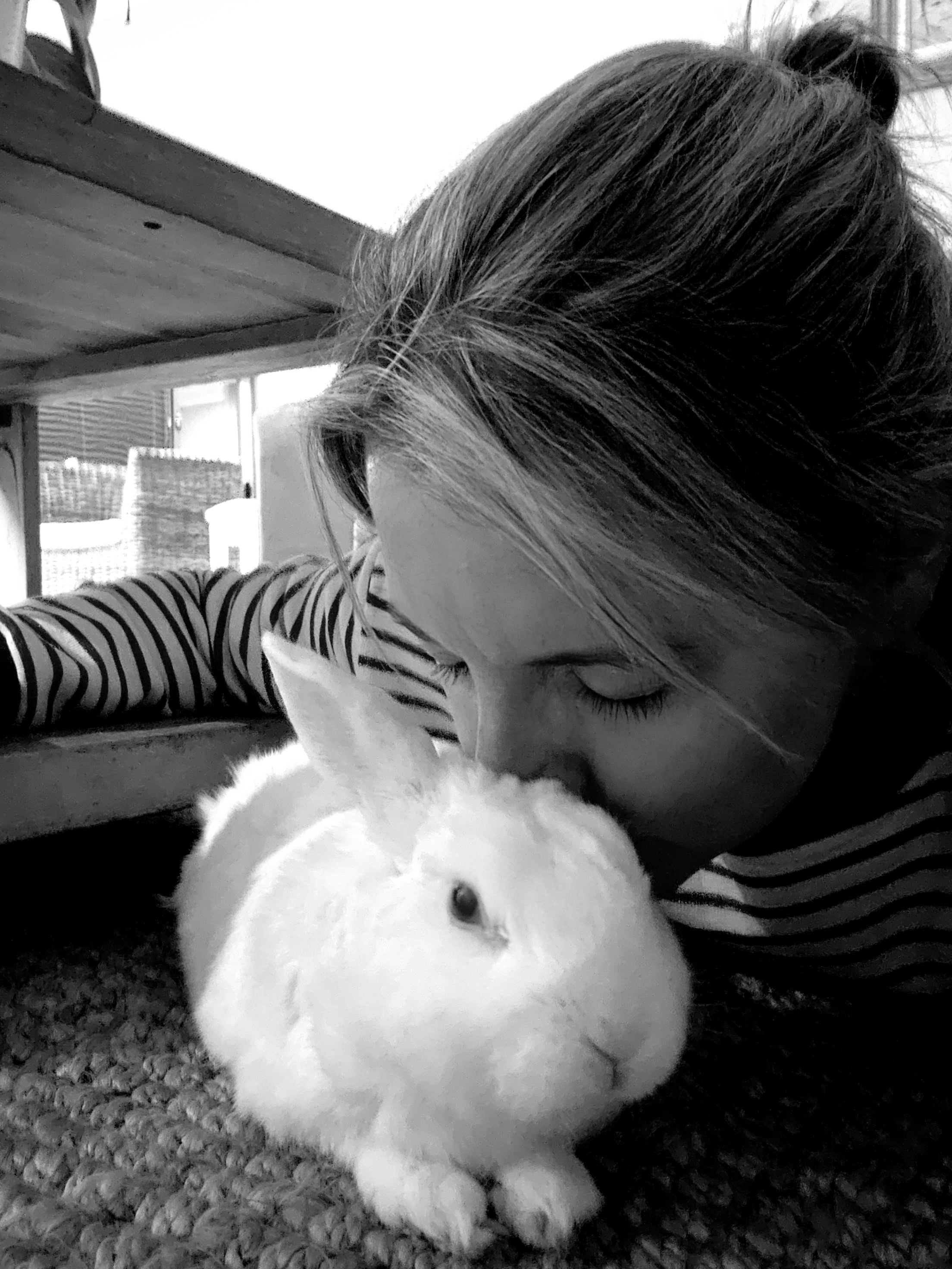 Face buried gently in Marshie's soft white fur