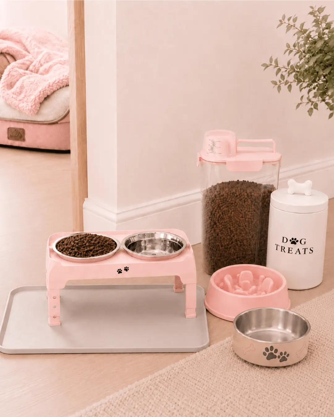 Pink puppy feeding corner with raised bowls, food storage and treat jar